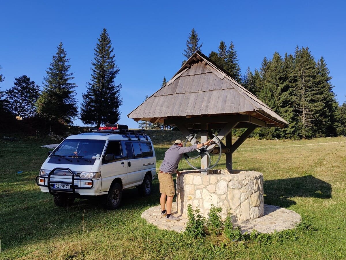 Wasservorräte im Camper auffüllen am Brunnen in Bosnien und Herzegowina